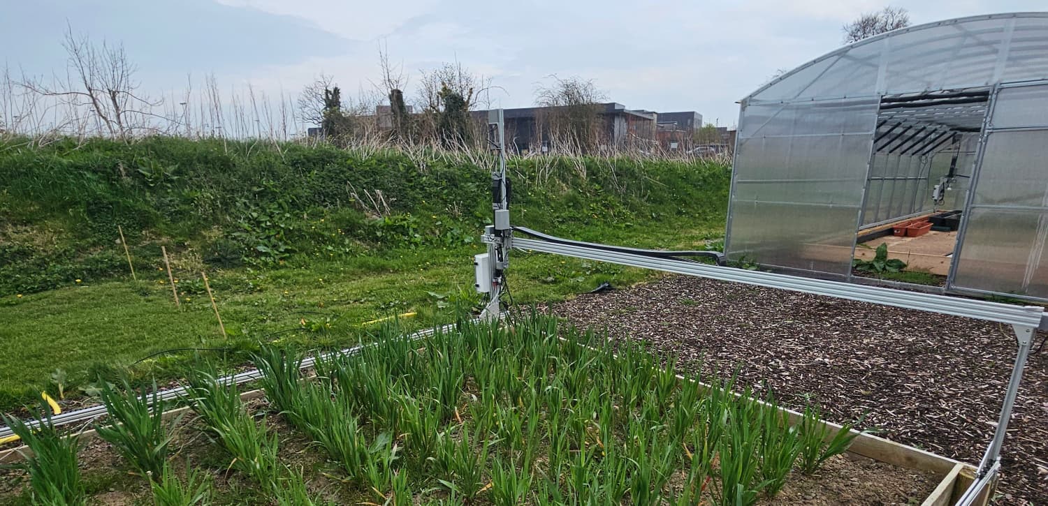 Maynooth farmbed gantry sensor rig alongside the greenhouse — capturing multispectral video of oat and barley plots.
